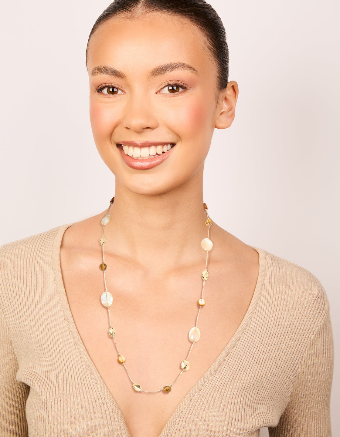 Designed with gold plated brown and cream stone cord necklace featuring beads in statement style on model view