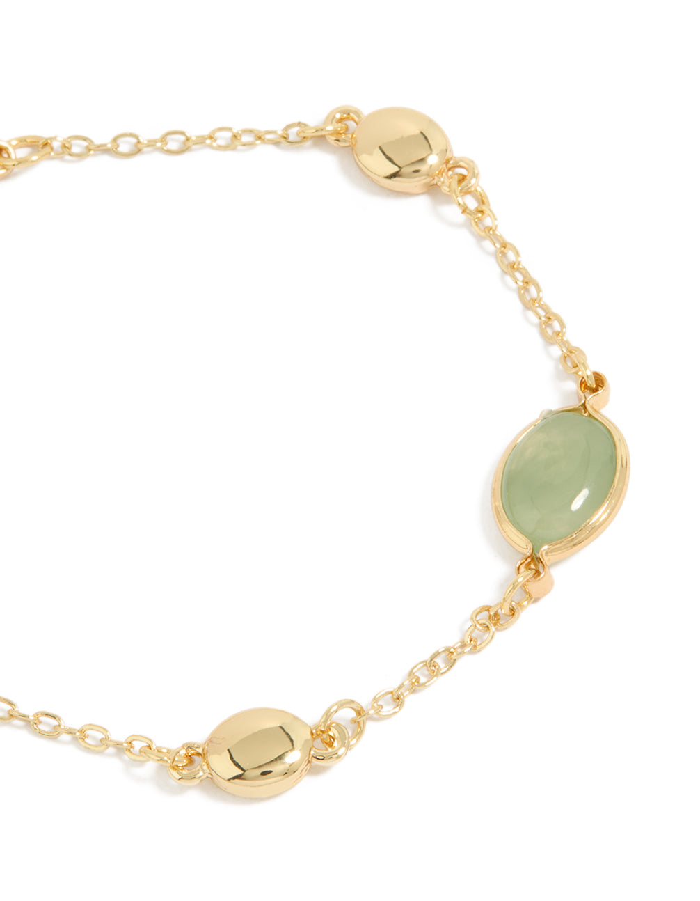 Featuring gold plated bracelet with oval cut stones in dark sea green close up view