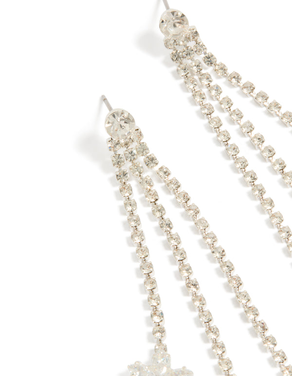 Highlighting silver diamante triple tassel drop earrings with floral accents in dainty style close up view