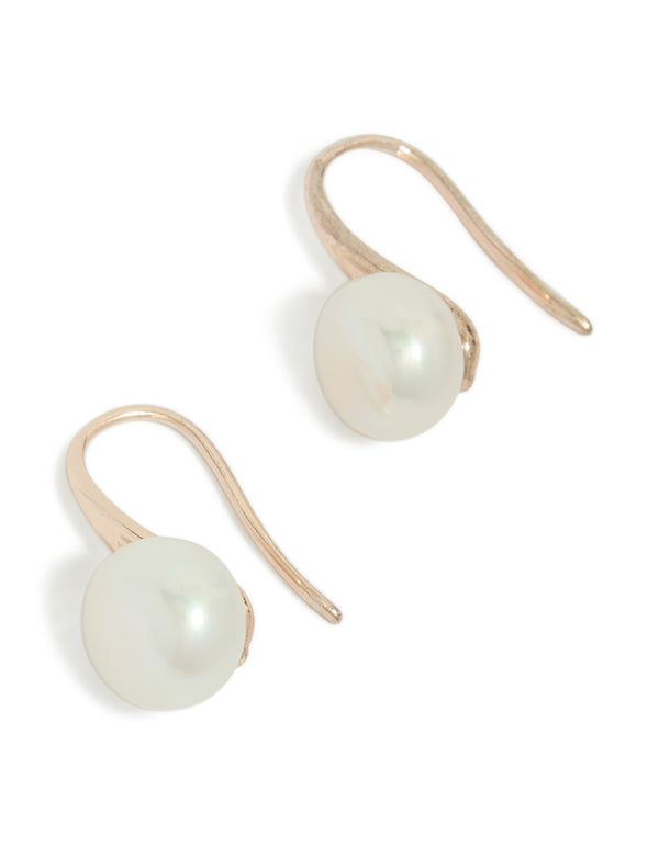 Showcasing rose gold plated small freshwater pearl hook drop earrings in dainty style front view