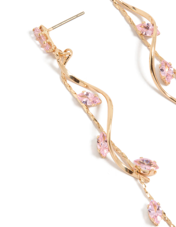 Showcasing gold pink diamante swirl vine drop earrings close up view