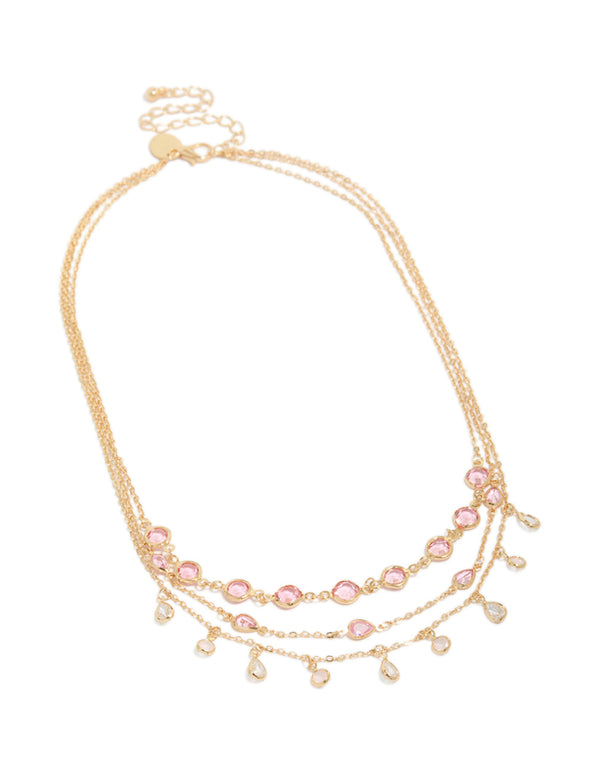 Showcasing a gold pink diamantes triple layered necklace with charm detailing in a statement style front view