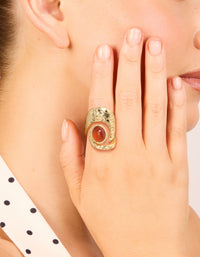 Showcasing a statement gold plated molten large stone ring with dark orange cabochon on finger view - link has visual effect only