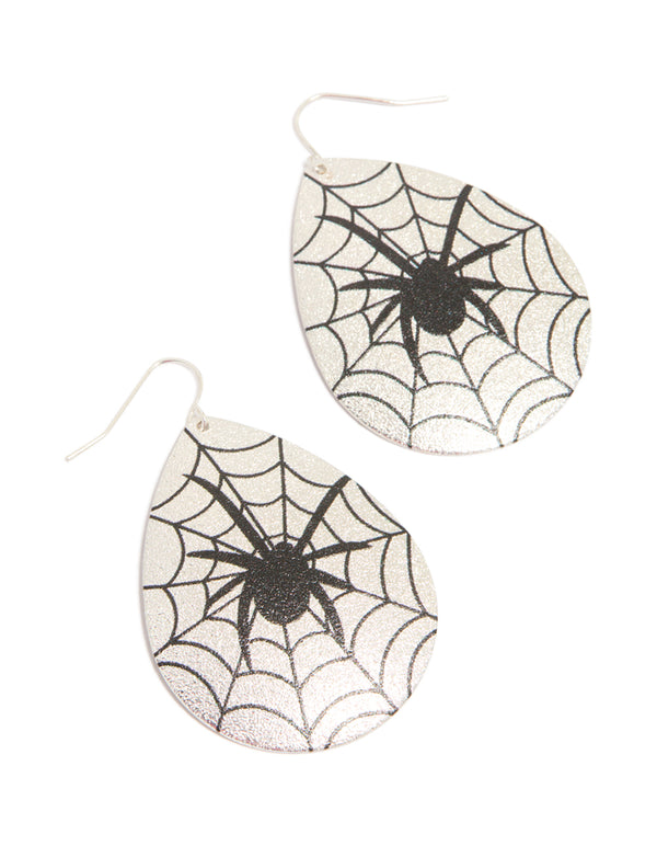 Showcasing statement disc earrings with spider motif and glitter detailing in silver and black front view