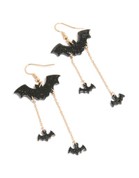 Discover Gold Bat Chain Drop Earrings featuring charm accents with glitter detail in black and gold tones front view - link has visual effect only