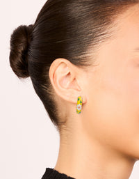 Discover huggie earrings with floral yellow enamel, pink flower and leaf prints in statement gold on ear view - link has visual effect only