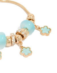Crafted with beaded charm bracelet and floral accents in gold and light blue close up view - link has visual effect only