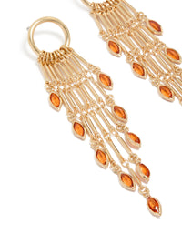 Detailed view of gold ring with long amber diamante chain drop earrings featuring statement charm and tassel close up view - link has visual effect only