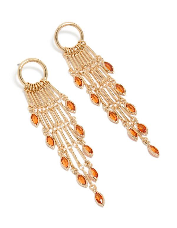 Showcasing gold ring with long amber diamante chain drop earrings featuring statement charm and tassel front view