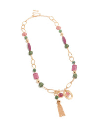 Featuring a gold pink and green acrylic beaded long fringe necklace with charm tassel in statement style front view - link has visual effect only