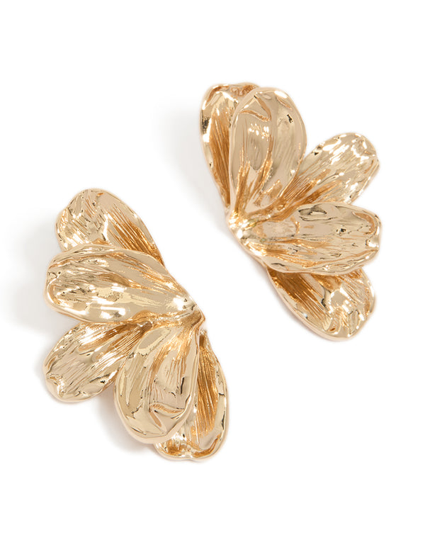 Showcasing large half flower stud earrings in gold with floral detailing front view