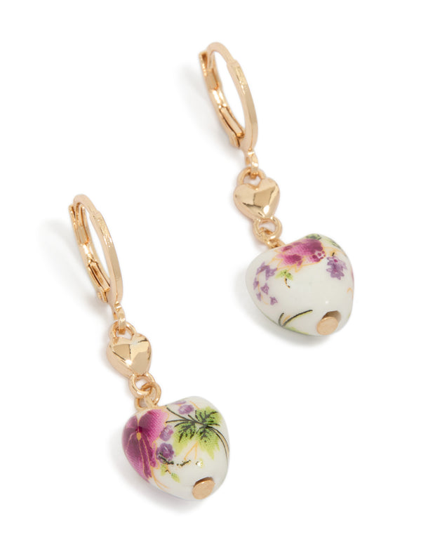 Showcasing gold beaded painted floral heart huggie earrings with charm in fuchsia, white, and lime green front view