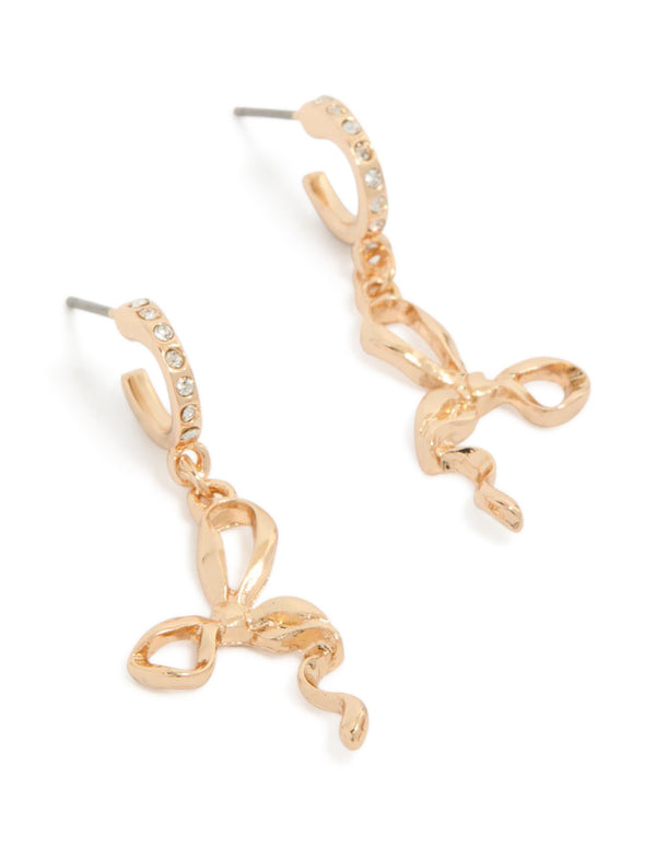 Beautifully crafted gold diamante bow huggie earrings front view