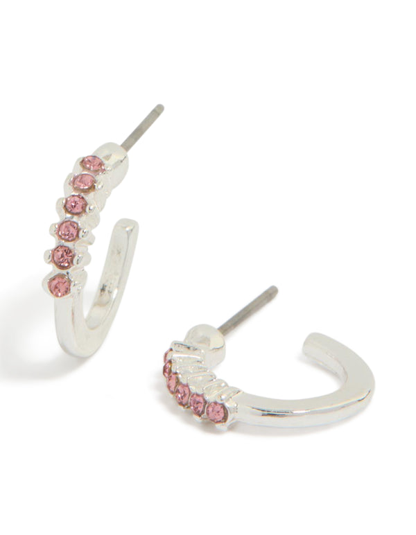 Showcasing silver pink diamante row huggie earrings with huggie closure in light front view