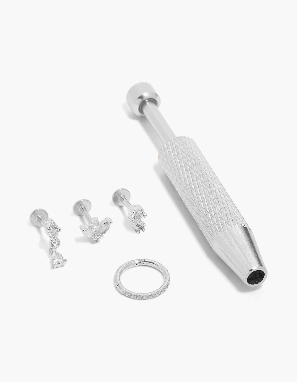 Discover this surgical steel flat back tool and cubic zirconia floral earrings pack featuring charm details with stud closure in silver and clear front view