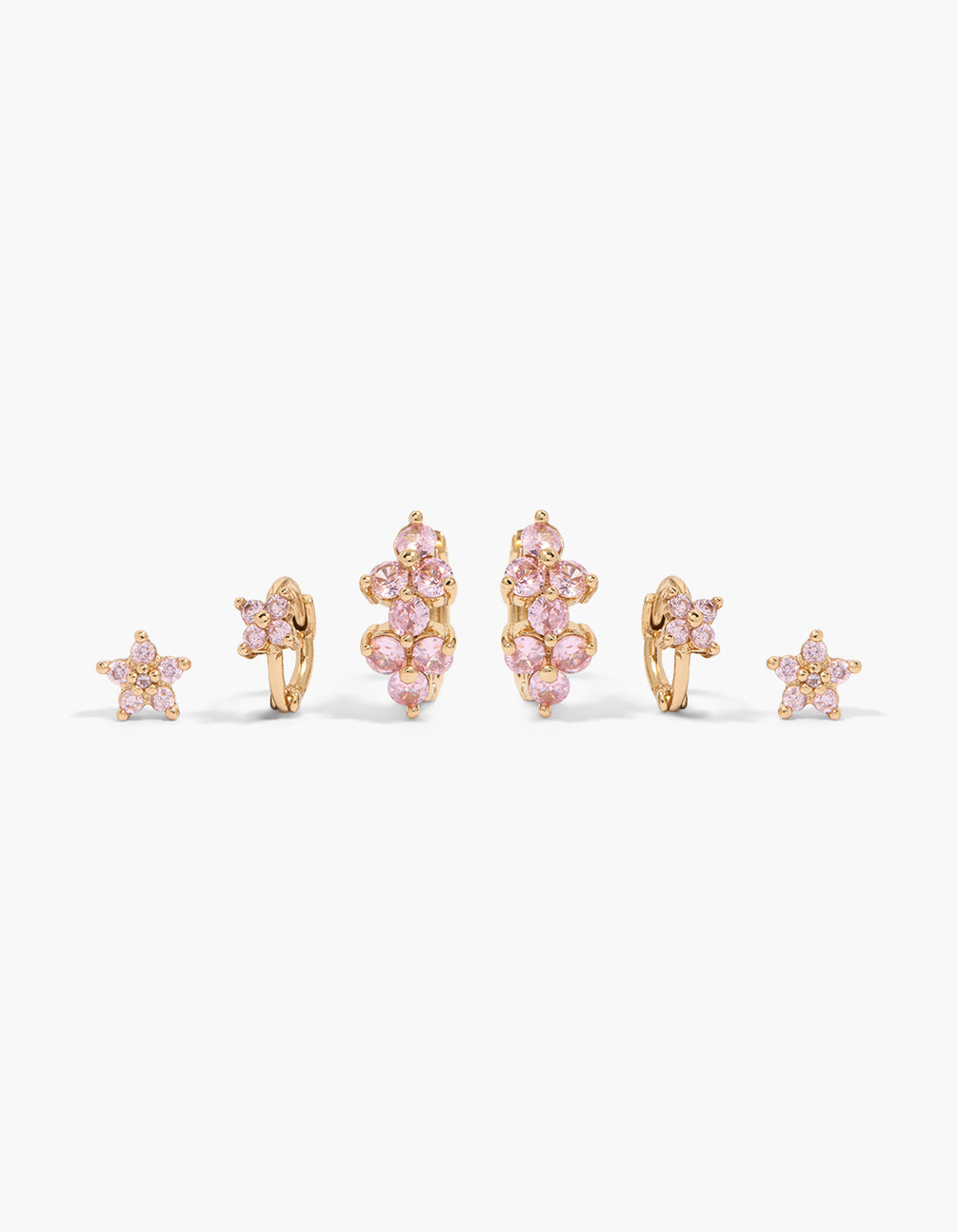Showcasing dainty floral stud and huggie earrings in a 3-pack with light pink cubic zirconia stones and gold finish front view