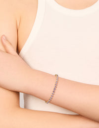 Elegant tennis bracelet with lilac cubic zirconia round stones in gold on wrist view - link has visual effect only