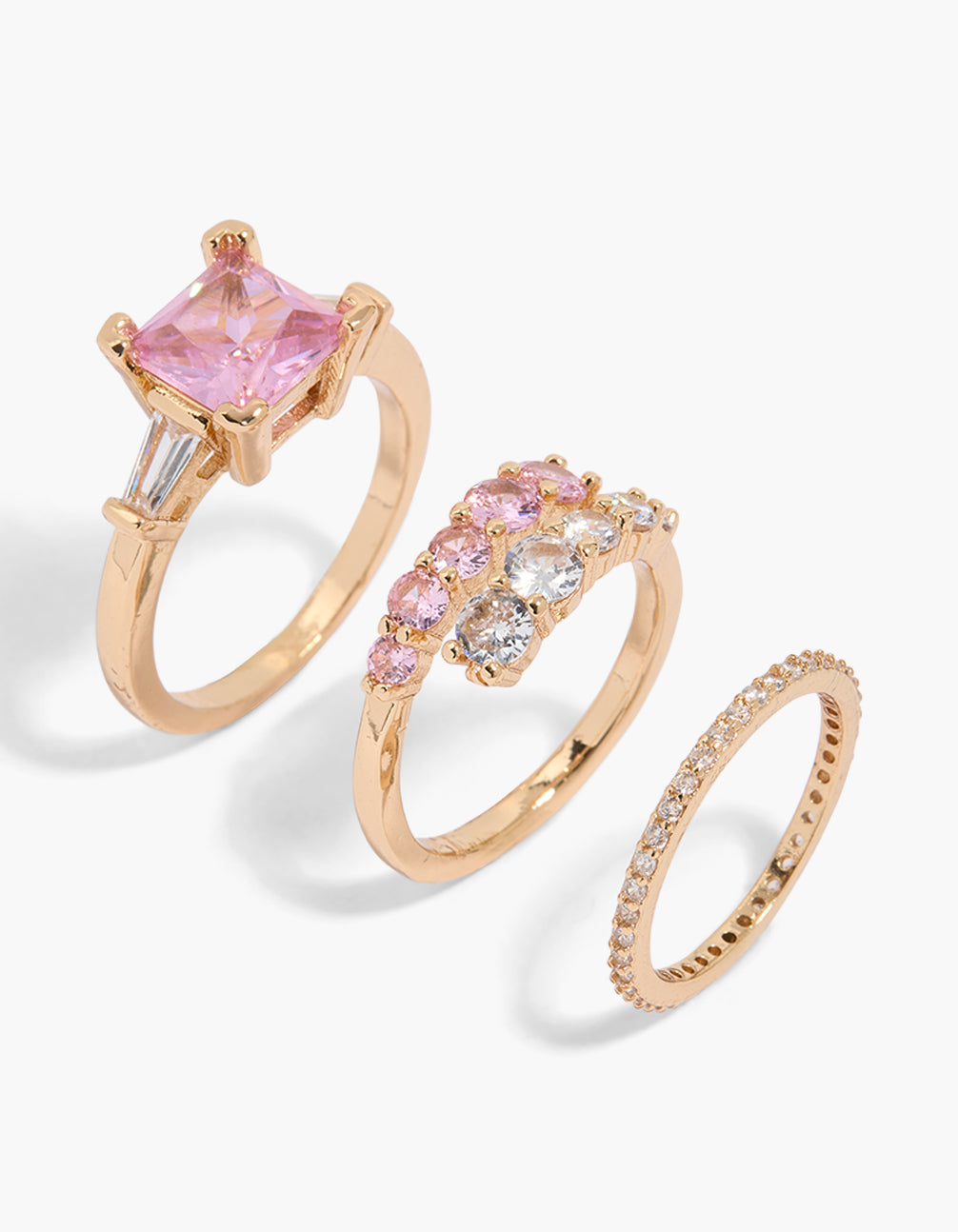 Discover this dainty 3-pack of gold rings featuring crystal and cubic zirconia in pink and clear tones front view