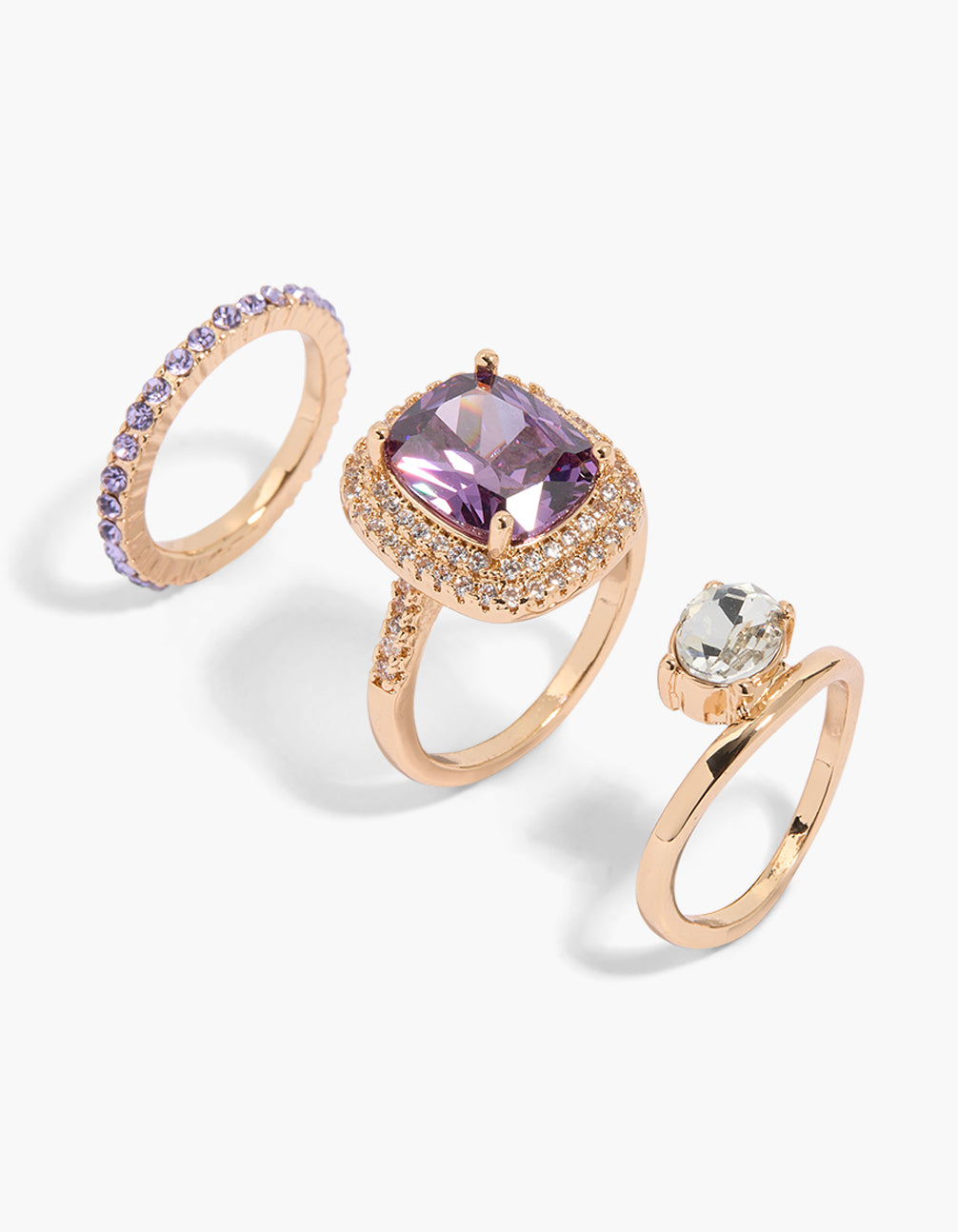 Showcasing a gold ring 3-pack featuring oval cut cubic zirconia in clear and purple front view
