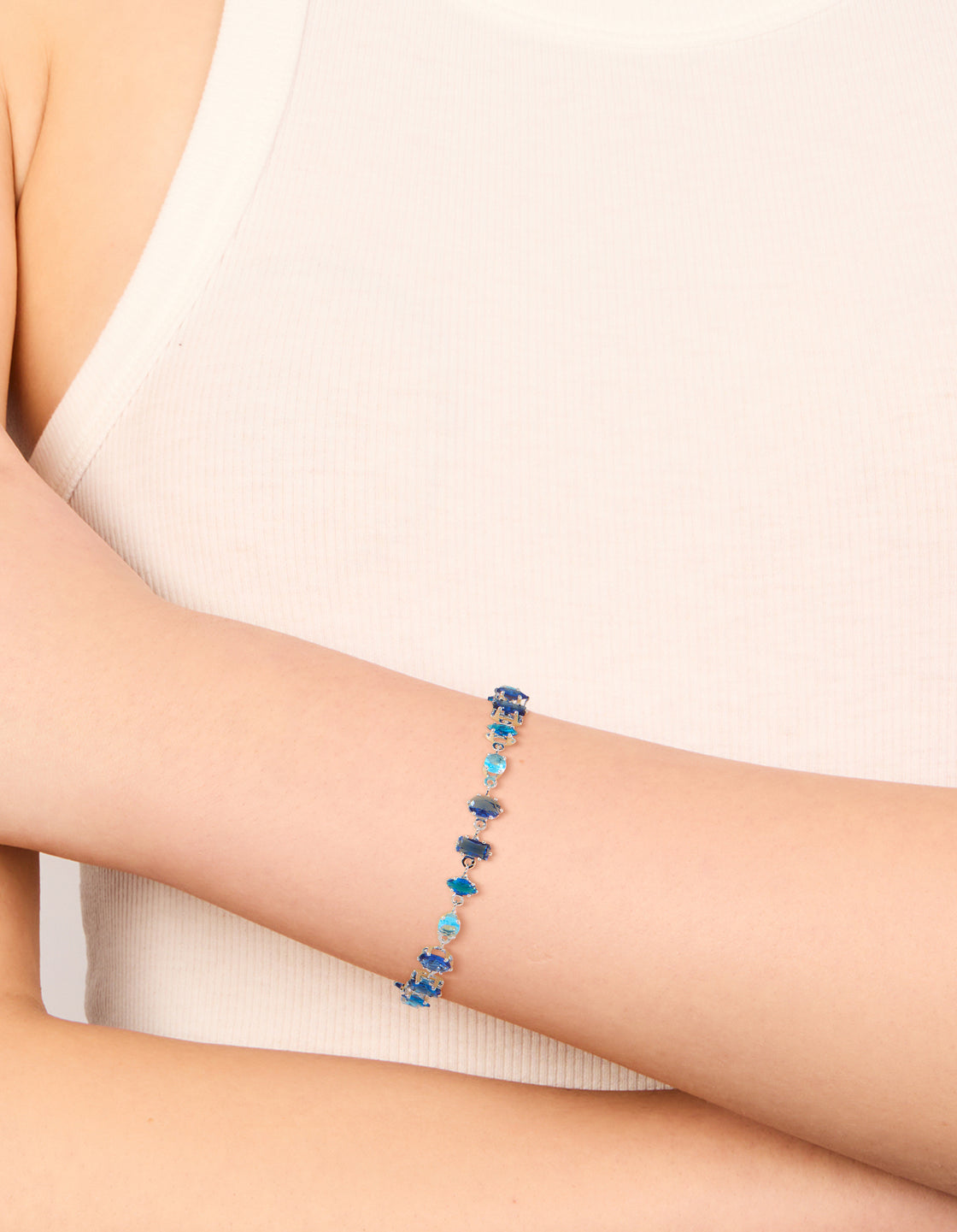 Featuring a dainty sapphire blue cubic zirconia bracelet in silver on wrist view